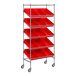 A Regency metal shelving unit with red slanted shelves and bins on wheels.