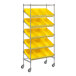A Regency metal shelving unit with slanted shelves holding yellow bins.