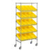 A Regency chrome metal shelf unit with yellow slanted shelves holding yellow bins.