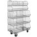 A Quantum chrome wire rack with three baskets on wheels.
