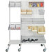 A white metal wall with Quantum chrome baskets and bins on it.