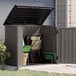 A Suncast stoney grey horizontal storage shed with a black metal handle on the door.