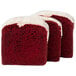 A close up of a red velvet cake with white frosting.