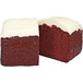 A piece of Sweet Sam's red velvet pound cake with white frosting.