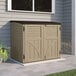 A tan Suncast outdoor storage shed on a patio.