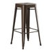 A brown metal Lancaster Table & Seating backless barstool with a seat.