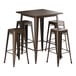 A Lancaster Table & Seating copper bar height table with 4 brown metal backless barstools.