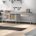 A Regency stainless steel open base work table in a kitchen.