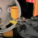 a person holding a wrench and a yellow tube