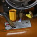 A yellow wrench and a yellow cup on a propane forklift safety valve.