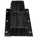A stack of black metal Ideal Warehouse dock bumper plates with holes in them.