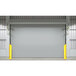 A white metal wall with a large industrial garage door with yellow Ideal Warehouse ECONO track protectors.