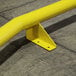 Ideal Warehouse yellow metal wheel guides on a concrete surface.