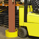 A yellow forklift with a black handle in a warehouse.