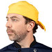 A man wearing a sunflower yellow Uncommon Chef bandana on his head.