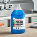 A blue CLR Pro Bio-Enzymatic Drain Maintainer container with a white label on a counter.