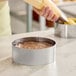 A round stainless steel mousse ring used for baking or molding desserts.