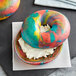 A close up of a Original Bagel rainbow bagel.