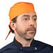 A man wearing an orange carrot print chef bandana.