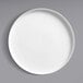 A Oneida Scandi bright white porcelain deep plate with a raised rim on a gray surface.