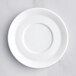 A close-up of a white Oneida Scandi porcelain cappuccino saucer with a white rim.