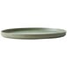 A close up of a Oneida Moira smoky basil stoneware plate with a green rim.