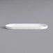 A Oneida Scandi bright white porcelain oval platter on a gray surface.