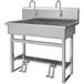 A Sani-Lav stainless steel utility sink with two foot-operated faucets.