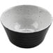 A close up of a black and white cheforward ramekin with a speckled design.