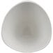 A black melamine bowl with a white interior and curved edge.