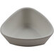 A white cheforward ramekin with a triangle shape on it.