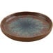 A round brown cheforward melamine plate with blue specks.