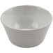 A white cheforward ramekin with a curved edge.
