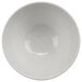 A white bowl with a white circle on a white surface.