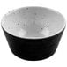 A white ramekin with black speckled dots.