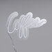 A white Canvas Freaks neon sign that says coffee.