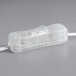 A clear plastic neon light in the shape of a pizza slice with a wire attached.