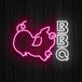 A Canvas Freaks neon sign with the word "BBQ" in white and pink neon with a pig.