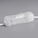 A clear plastic object with a white cord and a dimmer switch.