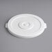 A white plastic lid with a circle on a gray surface.