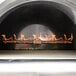 A Pinnacolo black hybrid wood/gas-fired pizza oven with flames inside.