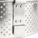 A close-up of a stainless steel Vollrath fryer basket with holes in it.