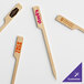 A customizable wooden boat oar pick with text on it.