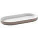 An oval mocha melamine serving platter on a counter.