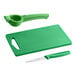 A green plastic cutting board with a knife and a spoon on it.