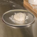 A ball of dough on an American Metalcraft aluminum pizza pan.