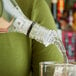 A person using a Choice 3-Ball Measured Liquor Pourer to pour a drink.