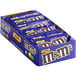 A box of M&M's Caramel Milk Chocolate Candy pouches on a counter.