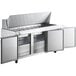 An Avantco stainless steel refrigerated sandwich prep table with three doors and a cutting board.