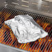 A roll of Backyard Pro aluminum foil on a grill.